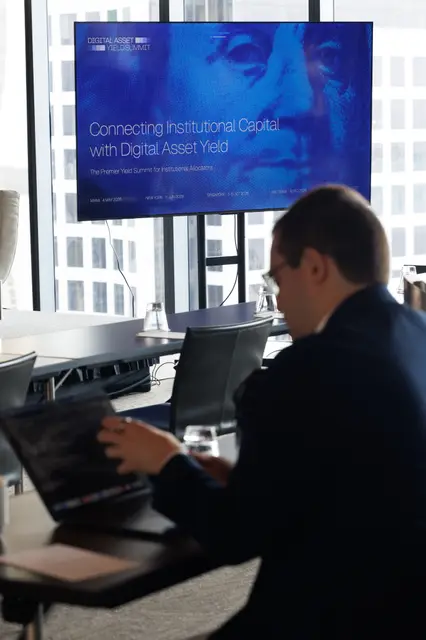 A delegate at work beneath the summit title slide