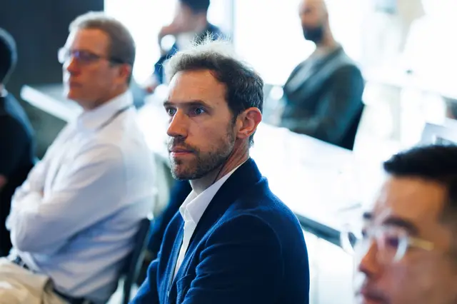 A focused delegate among the seated audience