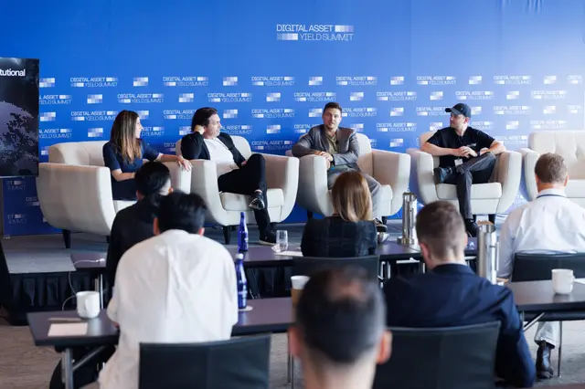 Four panellists in armchairs before the audience