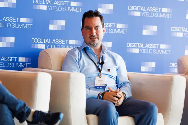 A speaker smiling during the fireside chat