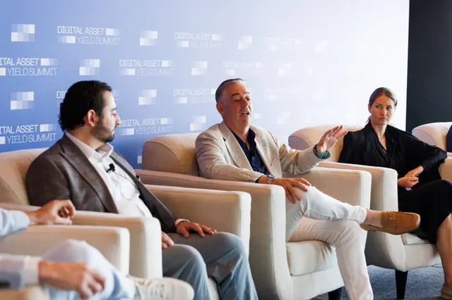 Three panellists in discussion on stage