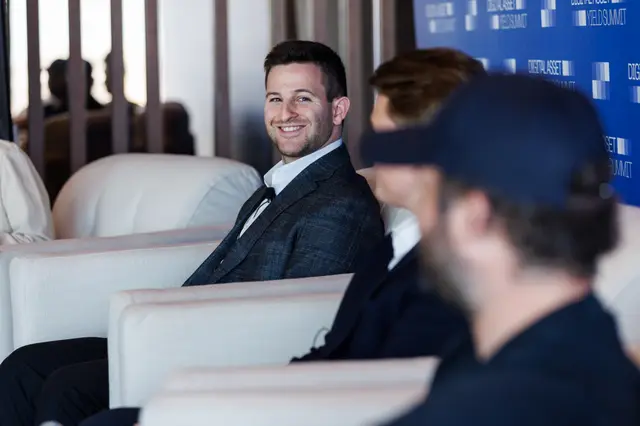 An attendee smiling during a lighter moment on stage